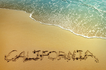 California written on the sand, with retro effect