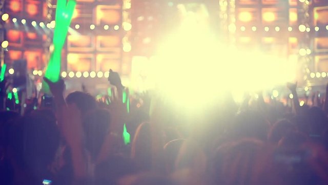 People at concert and light flares slow motion

