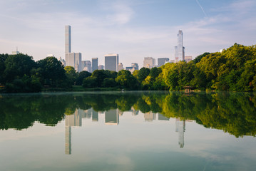 Buildings reflecting in The Lake, at Central Park, in Manhattan,