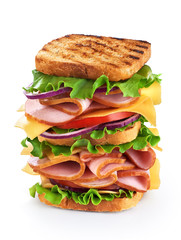 Big sandwich with ham and vegetables isolated on white backgroun
