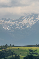 Snow capped mountains with hills in the foreground, Retezat, Romania