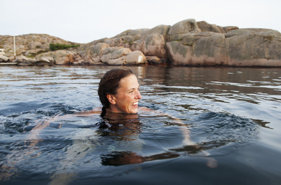 Sweden, Bohuslan, Lysekil, Stangholmesun, Woman swimming in sea 