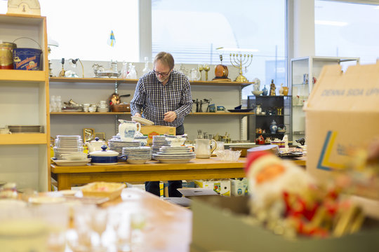 Sweden, Man choosing plates in store