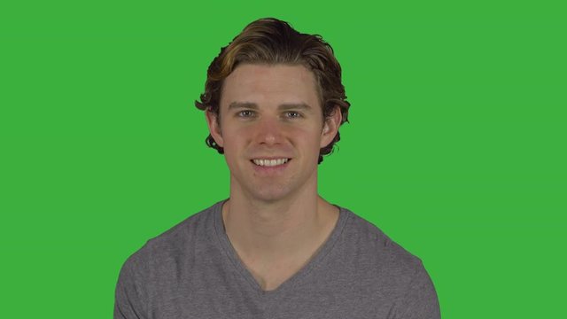 Friendly happy guy turns and smiles (Green Key)