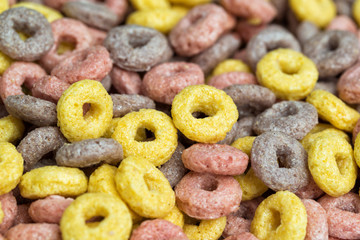 Colorful fruit cereals in a form of rings, close-up, food background
