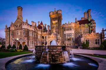 Fountain and Casa Loma at twilight, in Midtown Toronto, Ontario.