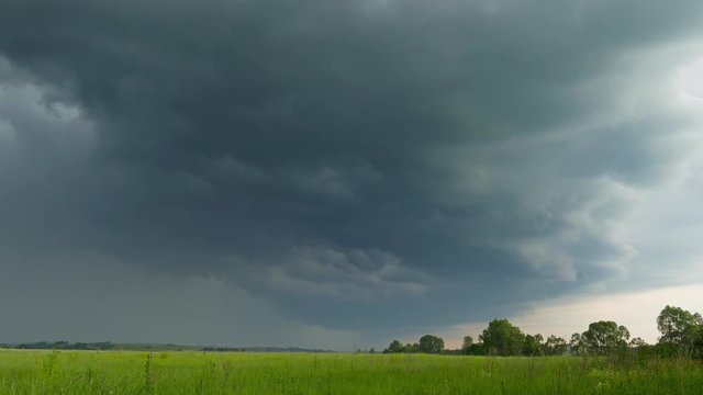 timelapse with dark storm clouds are moving over countryside field, 4k

