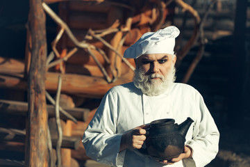 bearded cook with iron tea kettle