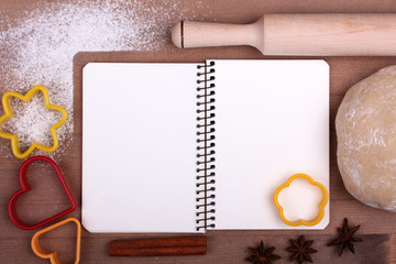 Recipe and menu background with copy space. The dough with  notebook on wooden table