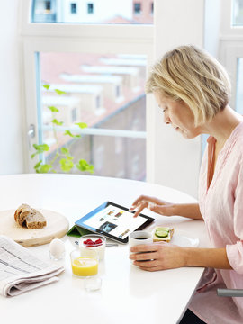 Picture of woman using digital tablet at home