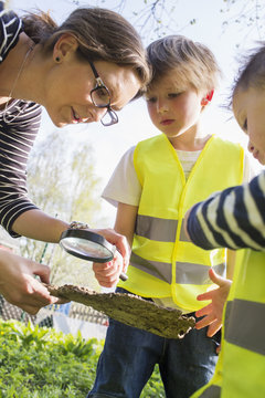 Sweden, Vastergotland, Olofstorp, Bergum, Woman taking care of children (2-3, 6-7) outdoors