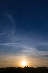 Obraz na płótnie Canvas Rising moon in dark blue sky with stars