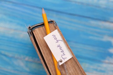 Thank you sign on pencil and old book - vintage style