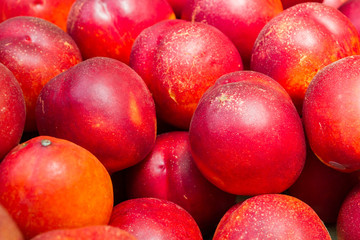 Delicious ripe fruit nectarine in the market on the counter