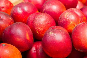 Delicious ripe fruit nectarine in the market on the counter