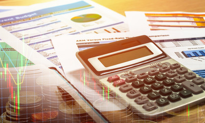 wooden office desk with open diary book and data chart, stock chart investment concept