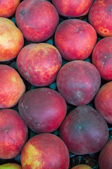 Delicious ripe fruit nectarine in the market on the counter