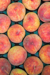 Delicious ripe peaches in the market on the counter