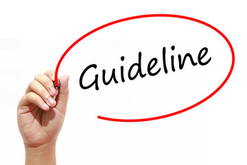 Man Hand writing Guideline with marker on transparent wipe board. Business, internet, technology concept.