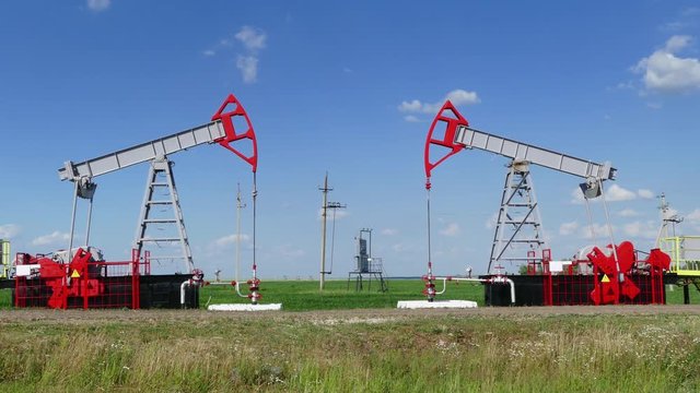 working oil pumps in a row at sunny day, 4k
