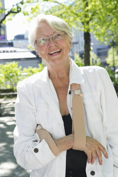 Sweden, Stockholm, Ostermalm, Portrait of senior woman wearing arm sling