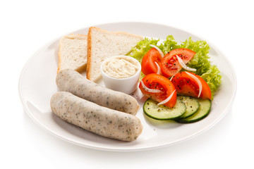 Breakfast - boiled white sausages, toasts and vegetables 