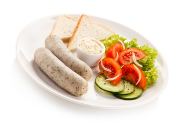 Breakfast - boiled white sausages, toasts and vegetables 