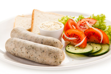 Breakfast - boiled white sausages, toasts and vegetables 