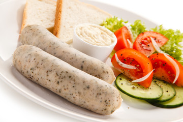 Breakfast - boiled white sausages, toasts and vegetables 