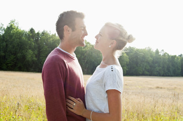 Sweden, Vastra Gotaland, Kallandso, Young couple face to face in field
