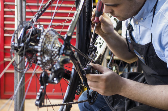 Finland, Pohjanmaa, Pietarsaari, Close-up of man repairing bicycle