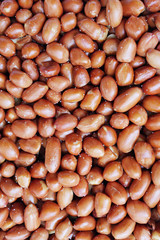 salted unpeeled peanuts, food or snack background close up shot