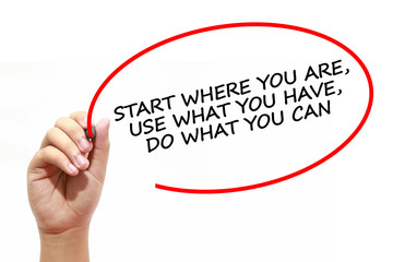 Man writing START WHERE YOU ARE, USE WHAT YOU HAVE, DO WHAT YOU CAN with marker on transparent wipe...