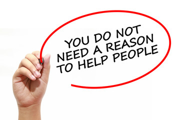 Man writing YOU DO NOT NEED A REASON TO HELP PEOPLE with marker on transparent wipe board.
