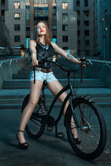 Obraz na płótnie Canvas Girl on bicycle at night.