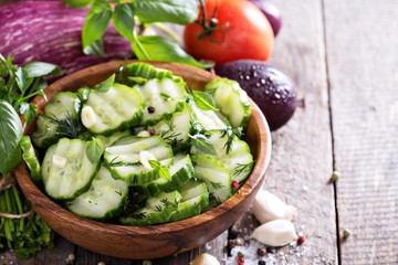 Pickled cucumber in a rustic wooden bowl