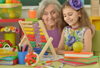 girl making homework with granny