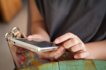 Woman using smartphone in cafe