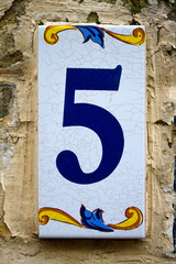 Five - street number on a wall