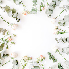 wreath frame with roses, eucalyptus branches, leaves and petals isolated on white background. flat lay, overhead view