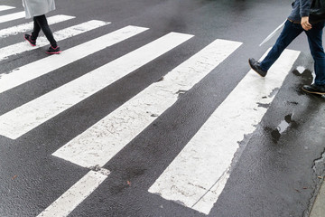 Close up wet crosswalk and walking step on city street, safety c © mrcmos