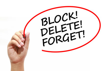 Man writing BLOCK! DELETE! FORGET! with marker on transparent wipe board.