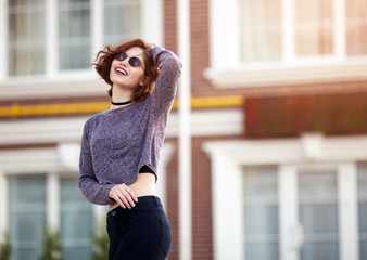 Outdoor fashion portrait of stylish hipster cool girl wearing sunglasses