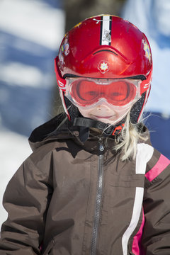 Norway, Osterdalen, Trysil, Portrait of smiling girl (4-5) standing on ski slope