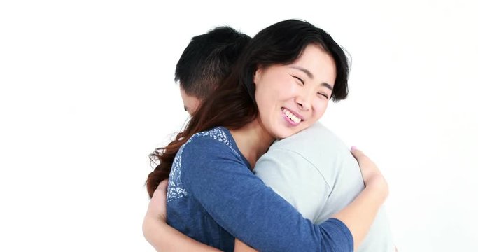 Happy couple hugging and looking at camera on white screen