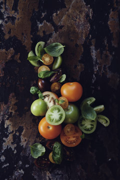 Tomatoes with basil on wooden table