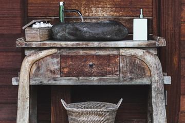 Wooden table with a stone sink and toiletries