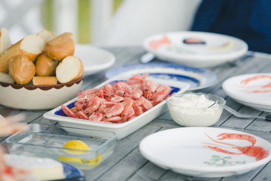Sweden, Vastkusten, Vastra Gotalands lan, Bohuslan, Havstenssund, Set table with shrimps and bread