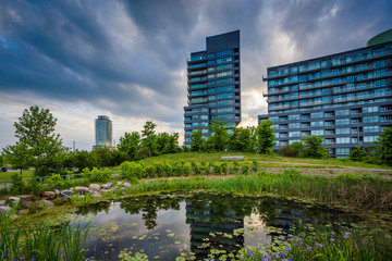 Pond and modern buildings at Corktown Common, in Toronto, Ontari