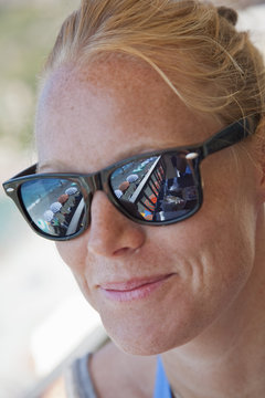 Italy, La Spezia, Cinque Terre, Monterosso al Mare, Smiling female tourist wearing sunglasses